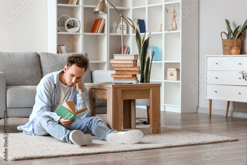 Young man reading book on f...