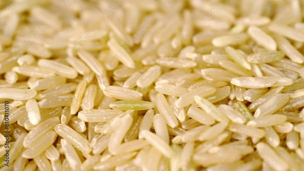 Whole grain brown rice texture. Top view, food background. Slow motion Whole grain brown rice texture. Top view, food background. Slow motion