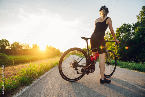 Portrait of a woman riding a bike during a sport cycling race outside of the city