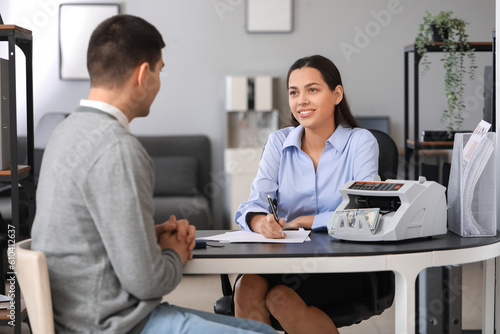 Female bank manager working with client in office
