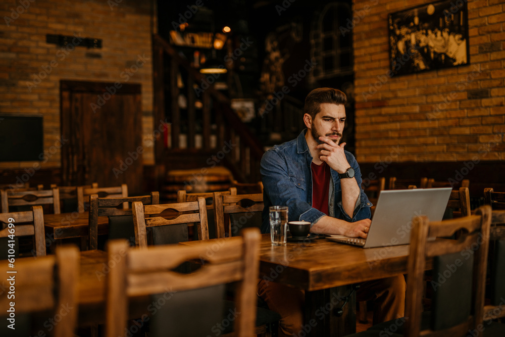 Mid adult man using the laptop for personal finances, electronic banking, or remote work Mid adult man using the laptop for personal finances, electronic banking, or remote work