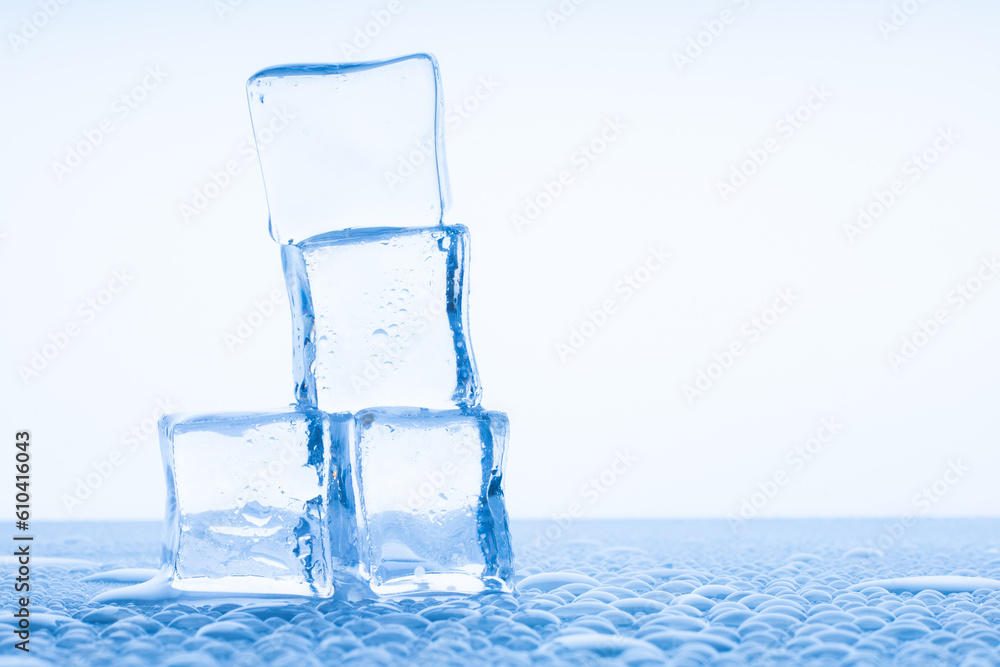 transparent Ice Cubes on a white table with reflection and water drops transparent Ice Cubes on a white table with reflection and water drops