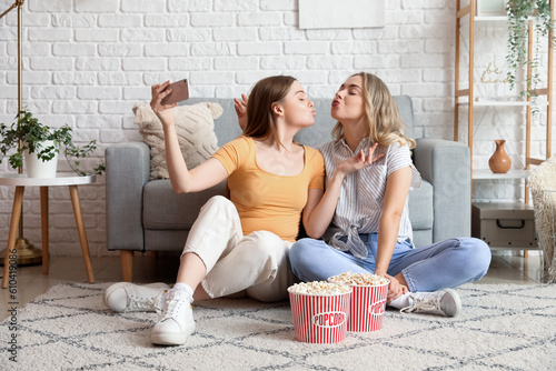 Two young women taking self...