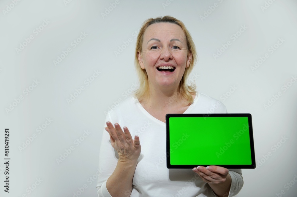 Cropped close up cutout portrait of smiling caucasian schoolgirl teenager child pupil student holding digital tablet showing blank screen with advert place mockup isolated Cropped close up cutout portrait of smiling caucasian schoolgirl teenager child pupil student holding digital tablet showing blank screen with advert place mockup isolated