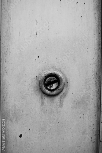 Vintage keyhole as a building detail in black and white.