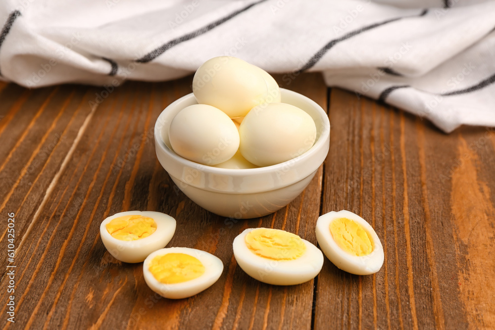 Bowl with boiled quail eggs on wooden background Bowl with boiled quail eggs on wooden background