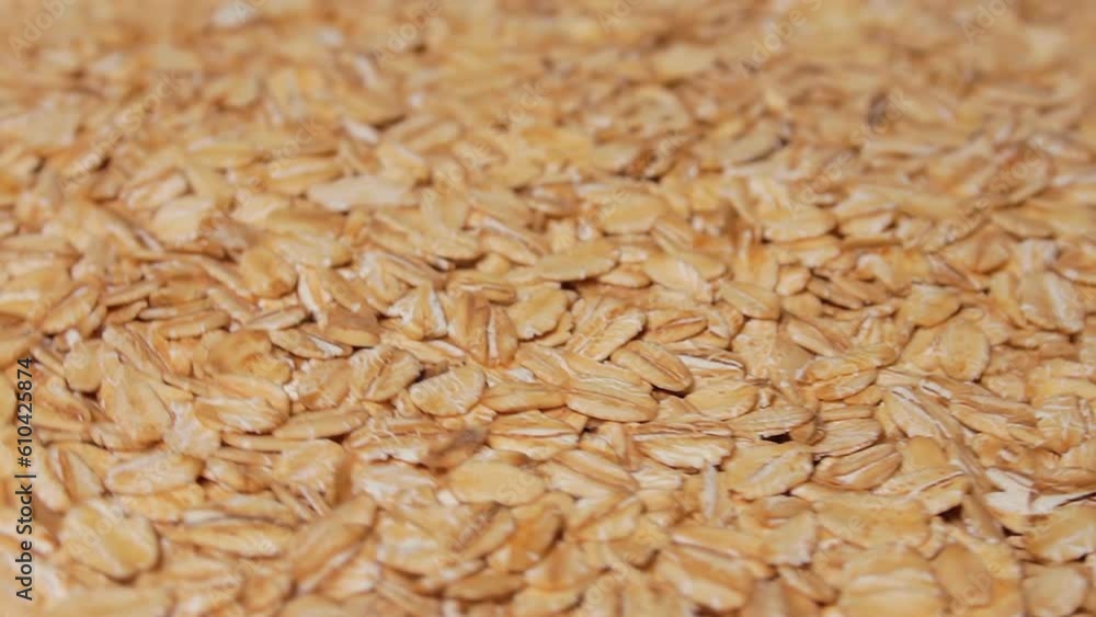 Uncooked Oat Flakes Rotating. Scattered Dry and Raw Oat Flakes. Healthy Breakfast and Diet Eating Ingredients Uncooked Oat Flakes Rotating. Scattered Dry and Raw Oat Flakes. Healthy Breakfast and Diet Eating Ingredients