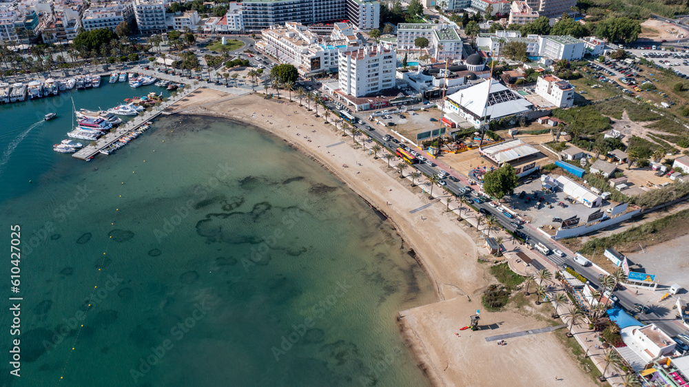 Aerial drone photo of a beach in the town of Sant Antoni de Portmany on the island of Ibiza in the Balearic Islands Spain showing the boating harbour and the beach known as Playa de San Antonio