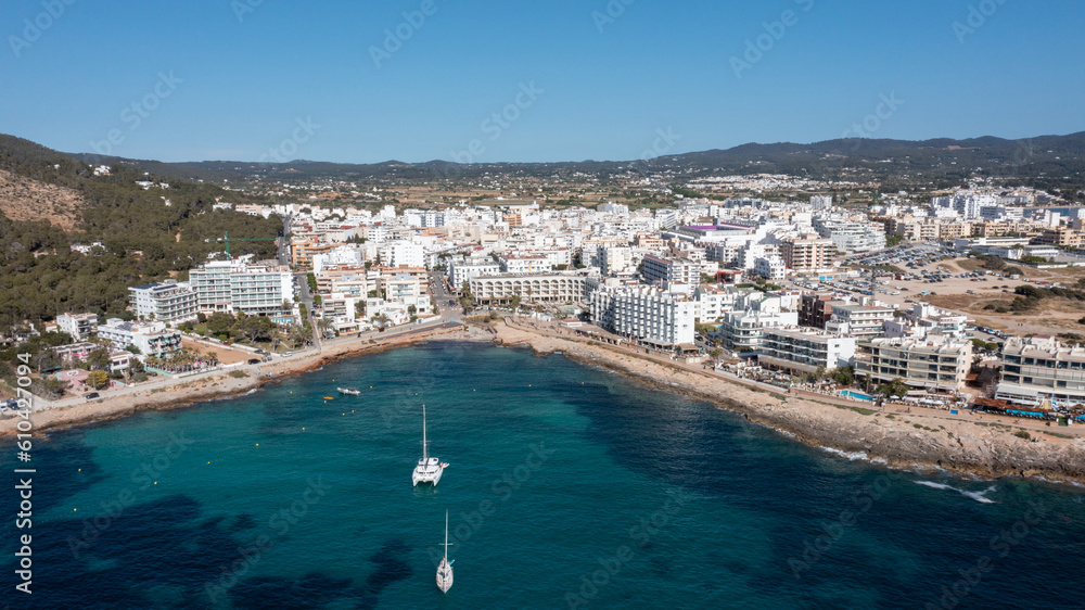 Aerial drone photo of a beach in the town of Sant Antoni de Portmany on the island of Ibiza Balearic Islands Spain showing the ocean front and Cala Alto de Porta beach in the summer time.