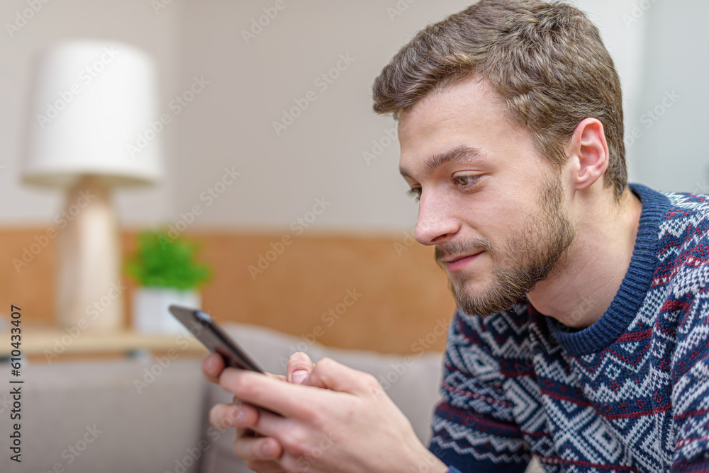 Young positive man with tablet computer in their hands, on the couch at home. Young positive man with tablet computer in their hands, on the couch at home.
