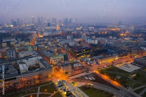 Aerial view of illuminated cityscape of Warsaw at spring twilight, Poland..
