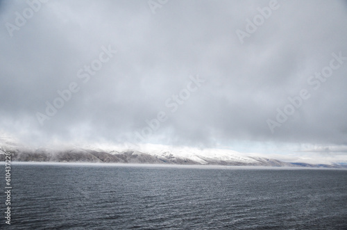 Low clouds over the mountains surrounding Lake Sevan on autumn day. Popular Armenian touristic destination.