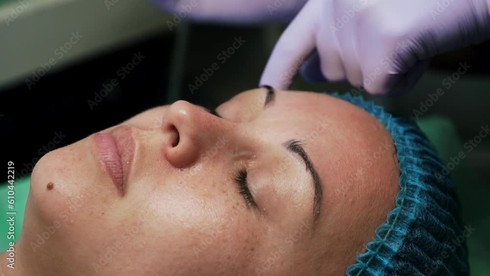 Woman having a procedure of face cleansing. Cosmetologist uses special ultrasonic scrubber for skincare. Extreme close up. Woman having a procedure of face cleansing. Cosmetologist uses special ultrasonic scrubber for skincare. Extreme close up.
