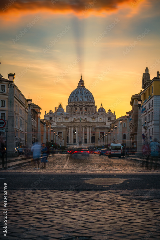 St. Peter's basilica at sunset viewed across Via della Conciliazione street  