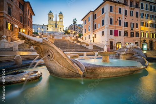 Fountain on the Piazza di Spagna square in Rome at dusk
