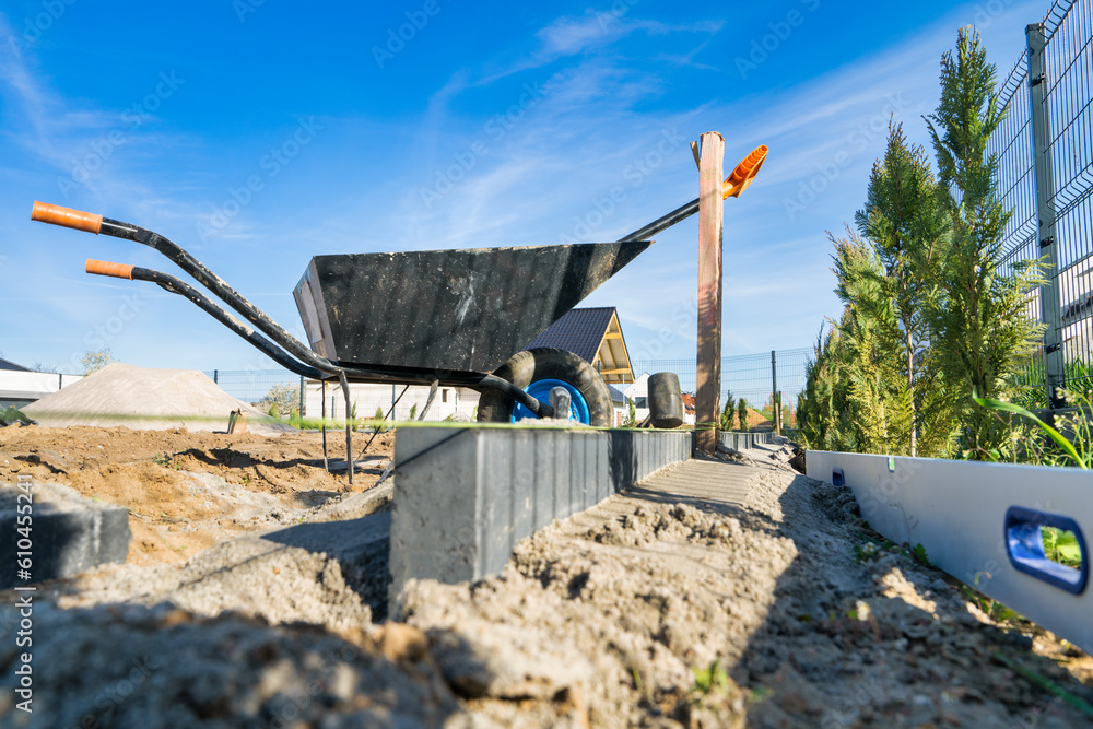 Building curb in the backyard using string for levelling and sand and ...