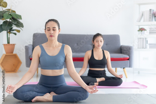 two women doing yoga, mindful meditation exercise concept