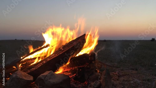 Campfire in the desert at sunset.