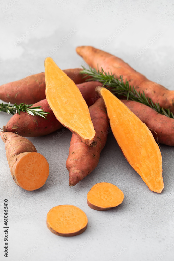 Raw sweet potatoes whole and cut. Orange kumara, sweet potato. Harvesting of root crops. Raw sweet potatoes whole and cut. Orange kumara, sweet potato. Harvesting of root crops.