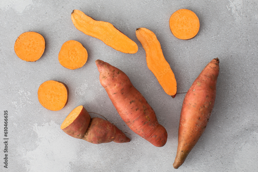 Raw sweet potatoes whole and cut. Orange kumara, sweet potato