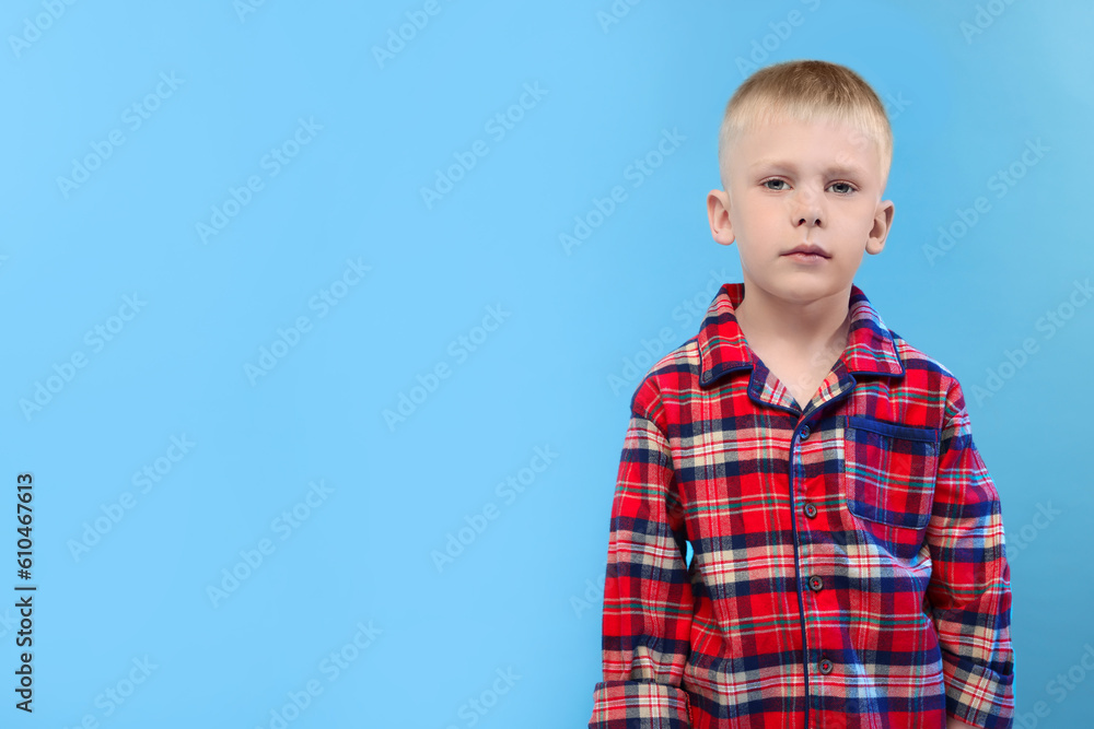 Sleepy boy on light blue background, space for text. Insomnia problem Sleepy boy on light blue background, space for text. Insomnia problem