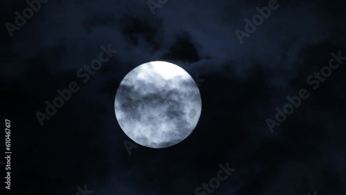 Clouds pass by full moon over sky footage, Telephoto. 