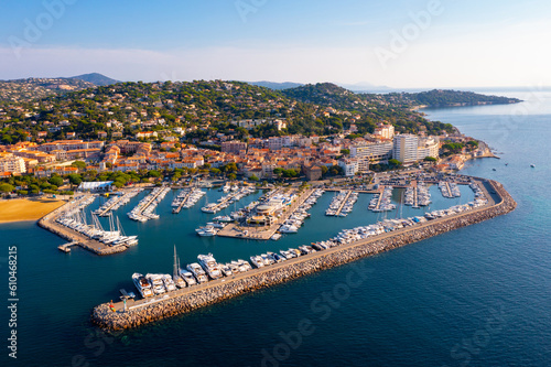 Fototapeta Naklejka Na Ścianę i Meble -  Picturesque view from drone of Sainte-Maxime townscape on Mediterranean coast with port for pleasure yachts on sunny autumn day, France
