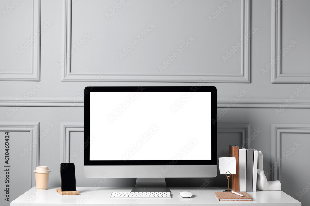 Cozy workspace with computer and stationery on white desk indoors Cozy workspace with computer and stationery on white desk indoors