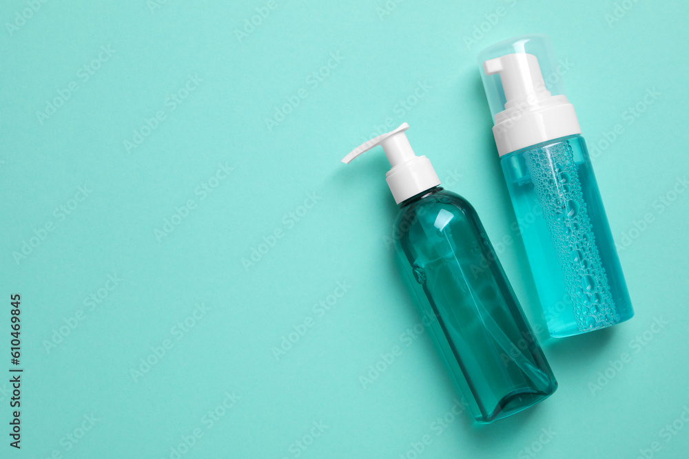 Different cleansers on turquoise background, flat lay and space for text. Cosmetic product Different cleansers on turquoise background, flat lay and space for text. Cosmetic product