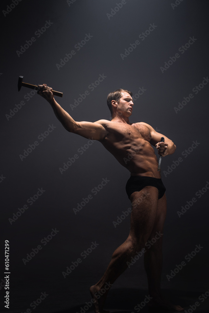 Obraz premium Create your own body, the concept of working on yourself. A muscular athlete sharpens his muscles with the help of a sculptor's tools