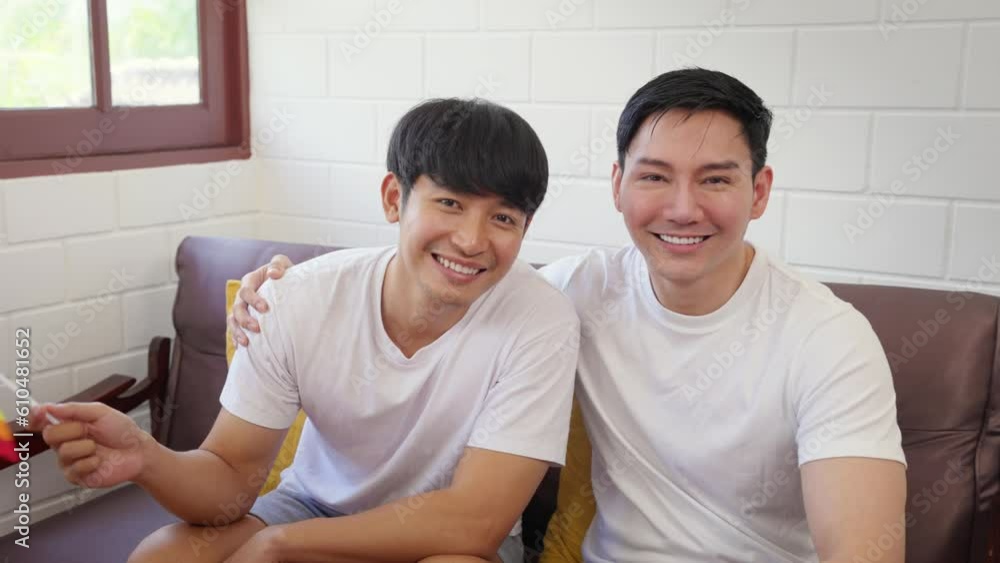 Portrait of Asian handsome man gay family holding LGBT flag and smile. Portrait of Asian handsome man gay family holding LGBT flag and smile.