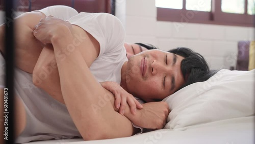 Asian handsome man gay couple lying down on bed and hugging each other.