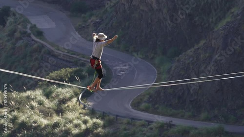 A young man taking a fall on a highline over a road in slow motion. Extreme sports. Argentina. photo