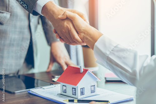 Fototapeta Real estate agent shakes hands with customer after finished contract after about