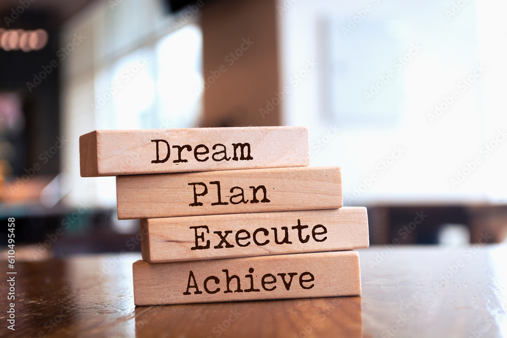 Wooden blocks with words 'Dream, plan, execute, achieve'. Wooden blocks with words 'Dream, plan, execute, achieve'.