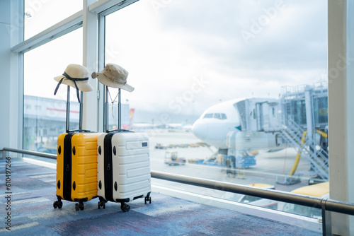Two suitcases in an empty airport hall, traveler cases in the departure airport terminal waiting for the area, vacation concept, blank space for text message or design