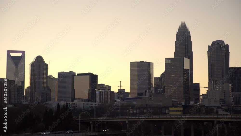 Lockdown Shot Of Vehicles Moving On Bridge By Skyscrapers In City At Sunset - Charlotte, North Carolina Lockdown Shot Of Vehicles Moving On Bridge By Skyscrapers In City At Sunset - Charlotte, North Carolina