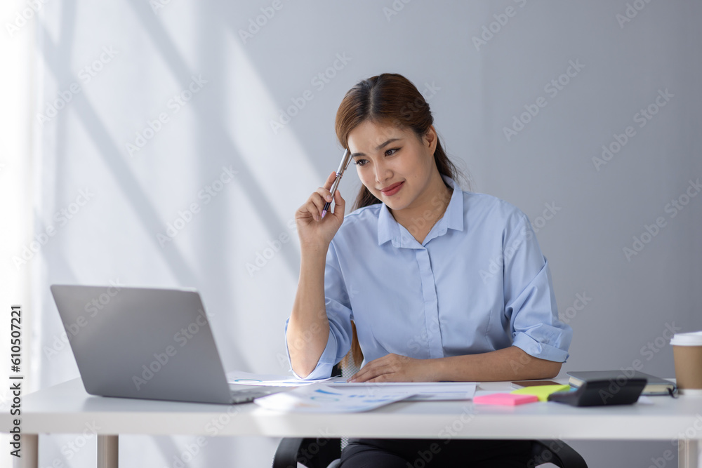 Asian Businesswoman Using laptop computer and working at office with calculator document on desk, doing planning analyzing the financial report, business plan investment, finance analysis concept.
Asian Businesswoman Using laptop computer and working at office with calculator document on desk, doing planning analyzing the financial report, business plan investment, finance analysis concept.