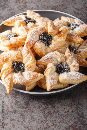 Joulutorttu Tahtitorttu Finnish Pinwheel Shaped Christmas Tarts close-up in a plate on a table. Vertical photo