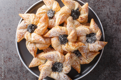 Joulutorttu aka Tahtitorttu are traditional Finnish Christmas Tarts that are specially eaten during Christmas and holiday season close-up in a plate on a table. Horizontal top view from above photo