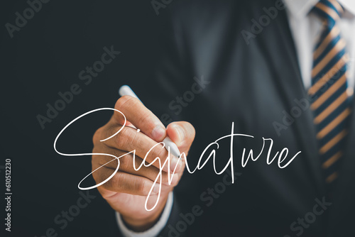 Digital entrepreneur signs electronic documents online on a black background. Depicts the online signing process, digital document management, and the paperless concept. Agreement is established. photo