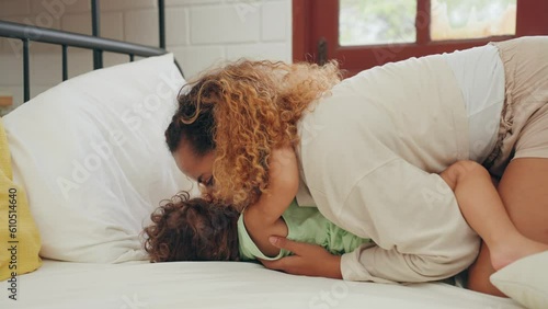 Happy Mom teasing daughter kiss and ticklish play having fun happy laughing on bed in bedroom at home.Family concept