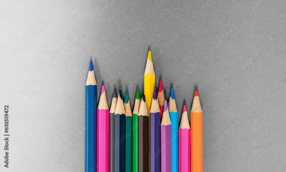 Standing Out From The Crowd concept. Colored pencils made with wood and with intense colours. Standing Out From The Crowd concept. Colored pencils made with wood and with intense colours.