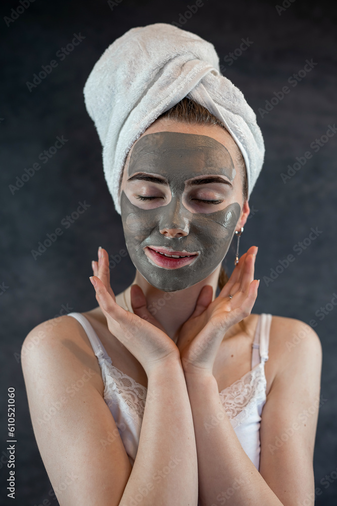 Green beauty clay mask on female face isolated on black Green beauty clay mask on female face isolated on black