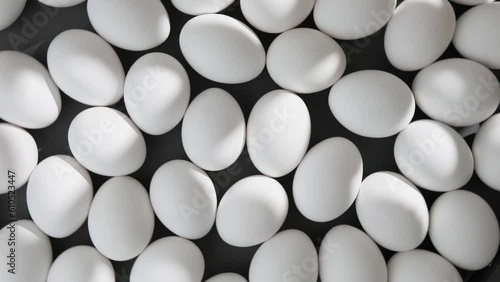 Many eggs rotate on a black background