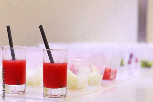 Concept of nutrition and healthy eating. A drink or watermelon juice next to fruit dishes