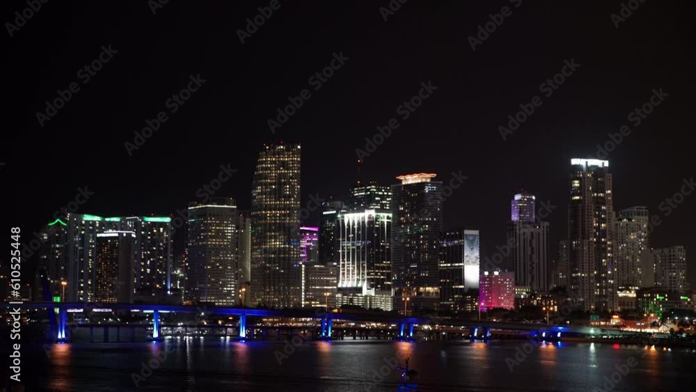 Lockdown Shot Of Illuminated Buildings By Sea In City At Night - Miami, Florida Lockdown Shot Of Illuminated Buildings By Sea In City At Night - Miami, Florida