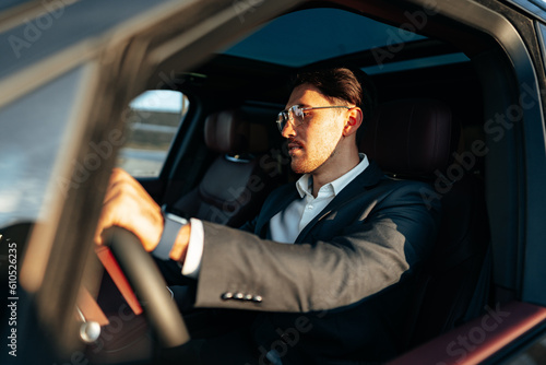 Young businessman in elegant suit driving luxury car © fotofabrika