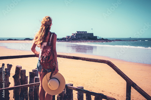Tour tourism in Saint Malo, woman tourist looking at National fort- Brittany in France