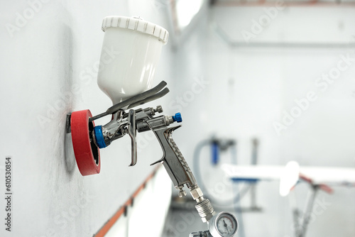 Foto Airbrush paint gun in paint in car service station